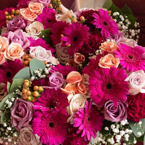 bride and bridesmaids holding wedding bouquets up close