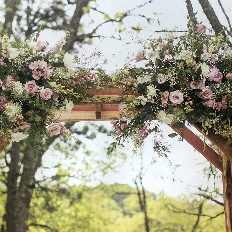 Wooden wedding awning with flower bouquet