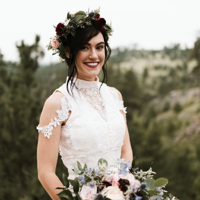 Bride holding her flower bouquet and flower crown