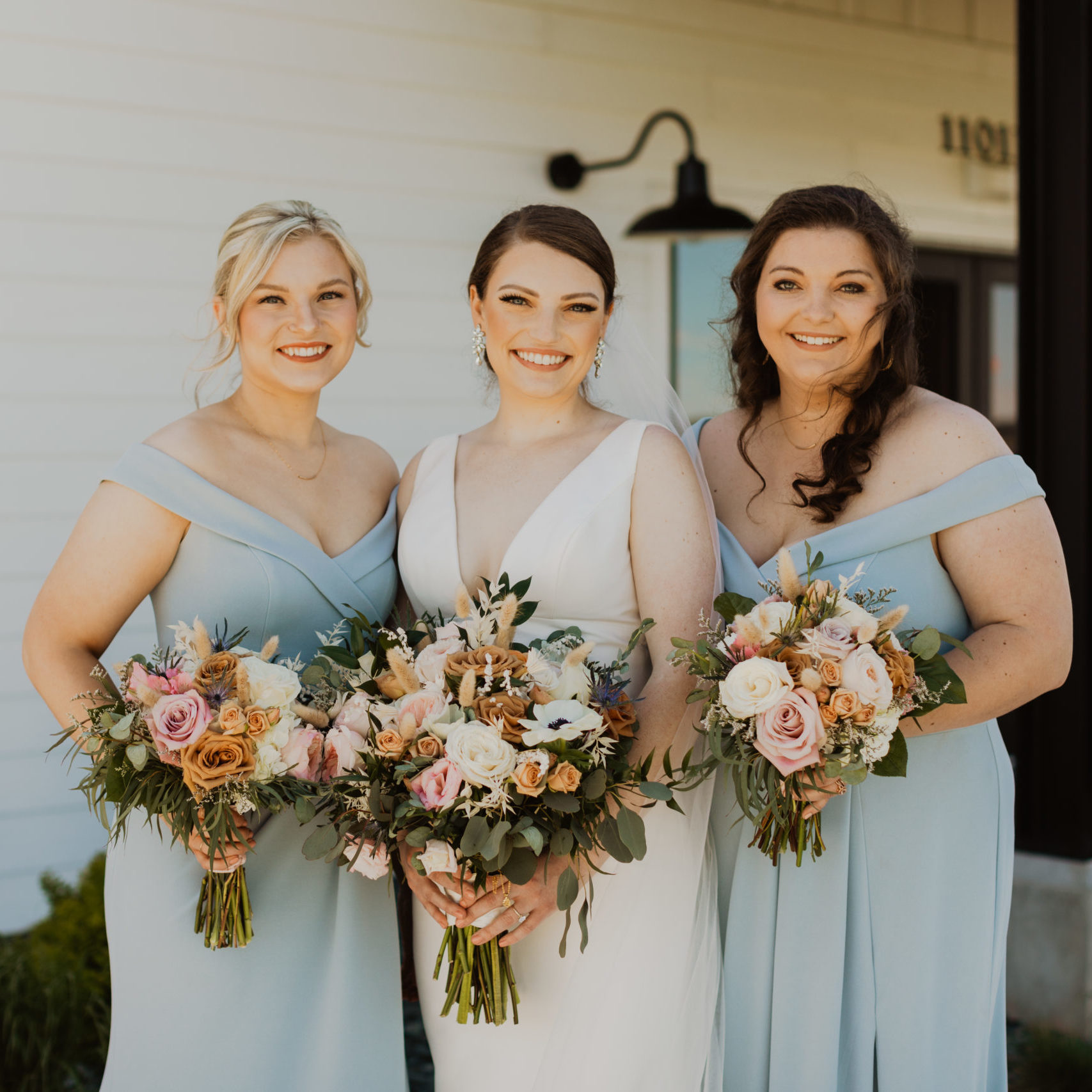 Kaite and her bridesmaids holding custom flower bouquets