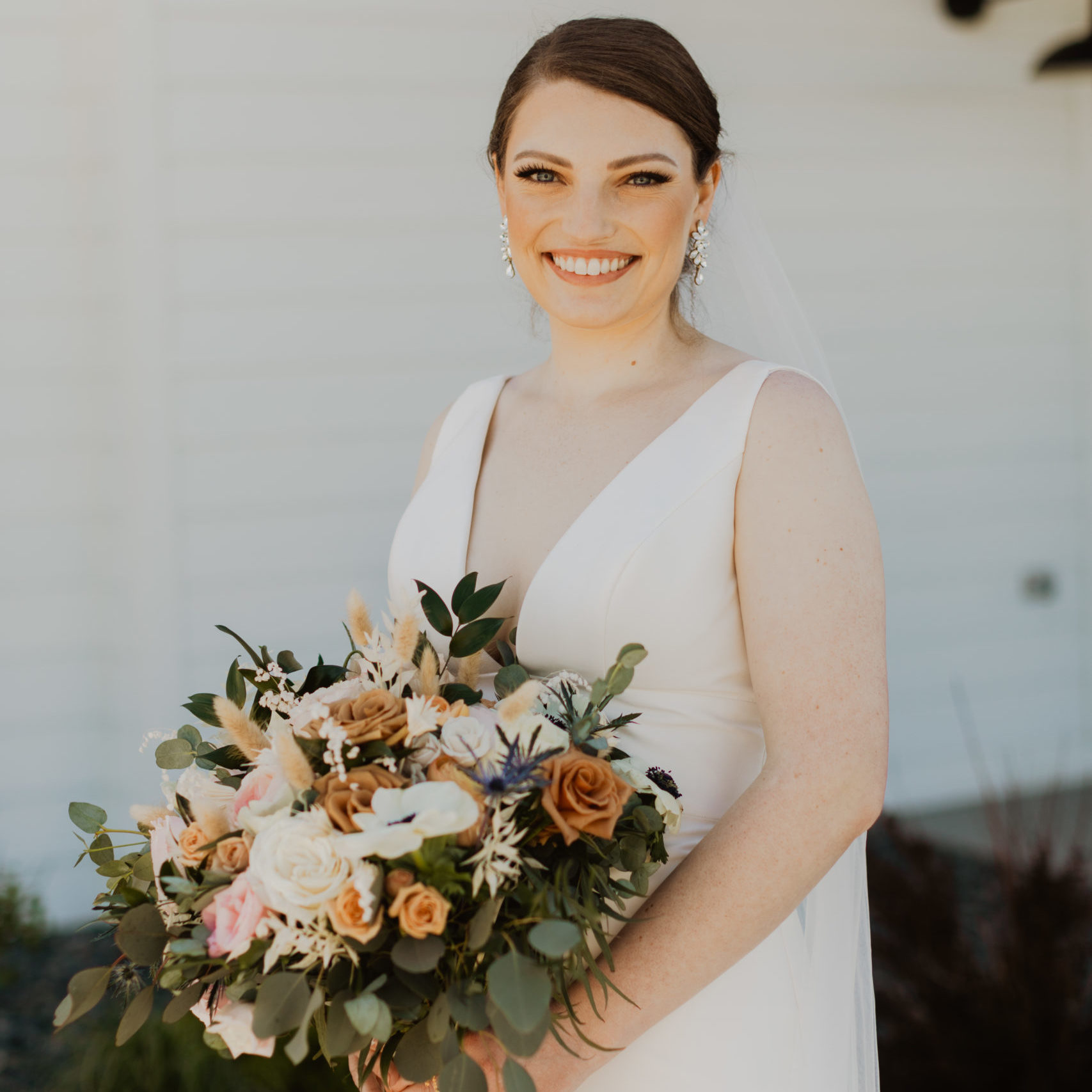 Bride holding flower arrangement